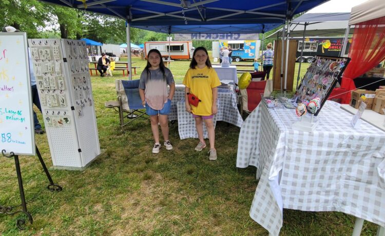 While at our Millington, TN market on May 6th, we got to meet the Glitter Girls! Sophia, 13 and Abby, 11, ran their booth with the 
help of their 4-year-old sister Gwen. This was their first market and they talked to, and hair tinseled, our Nashville manager, Amanda!