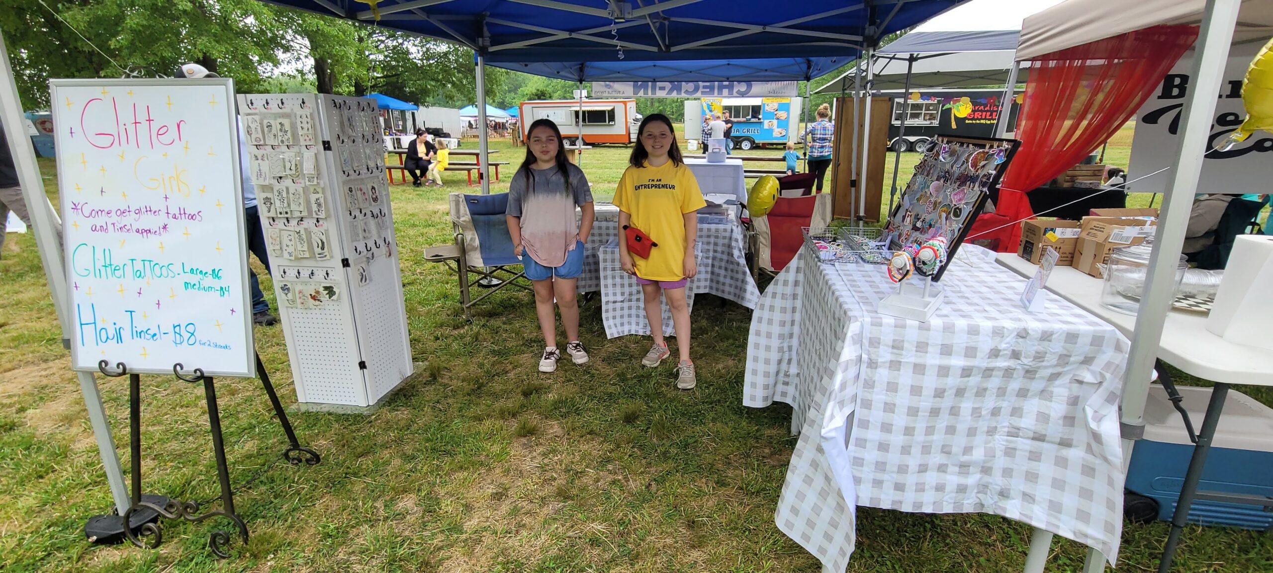 Glitter Girls While at our Millington, TN market on May 6th, we got to meet the Glitter Girls! Sophia, 13 and Abby, 11, ran their booth with the
help of their 4-year-old sister Gwen. This was their first market and they talked to, and hair tinseled, our Nashville manager, Amanda!